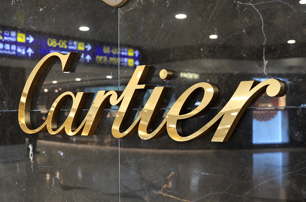 Close-up of polished gold dimensional letters on a stone wall